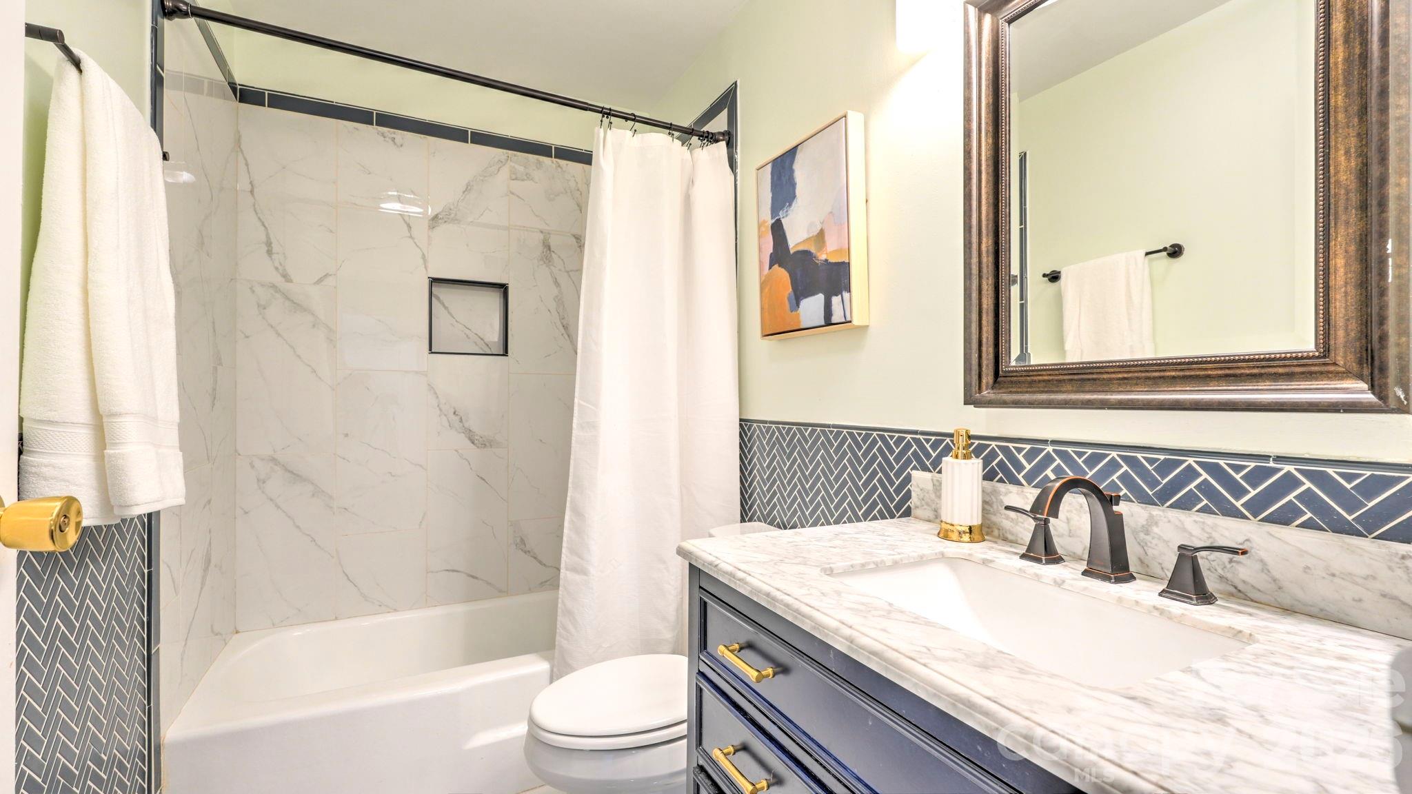 2626 Park Road, Unit B Charlotte, NC 28209 - Photo 11 of 31 a bathroom with a granite countertop sink toilet and shower