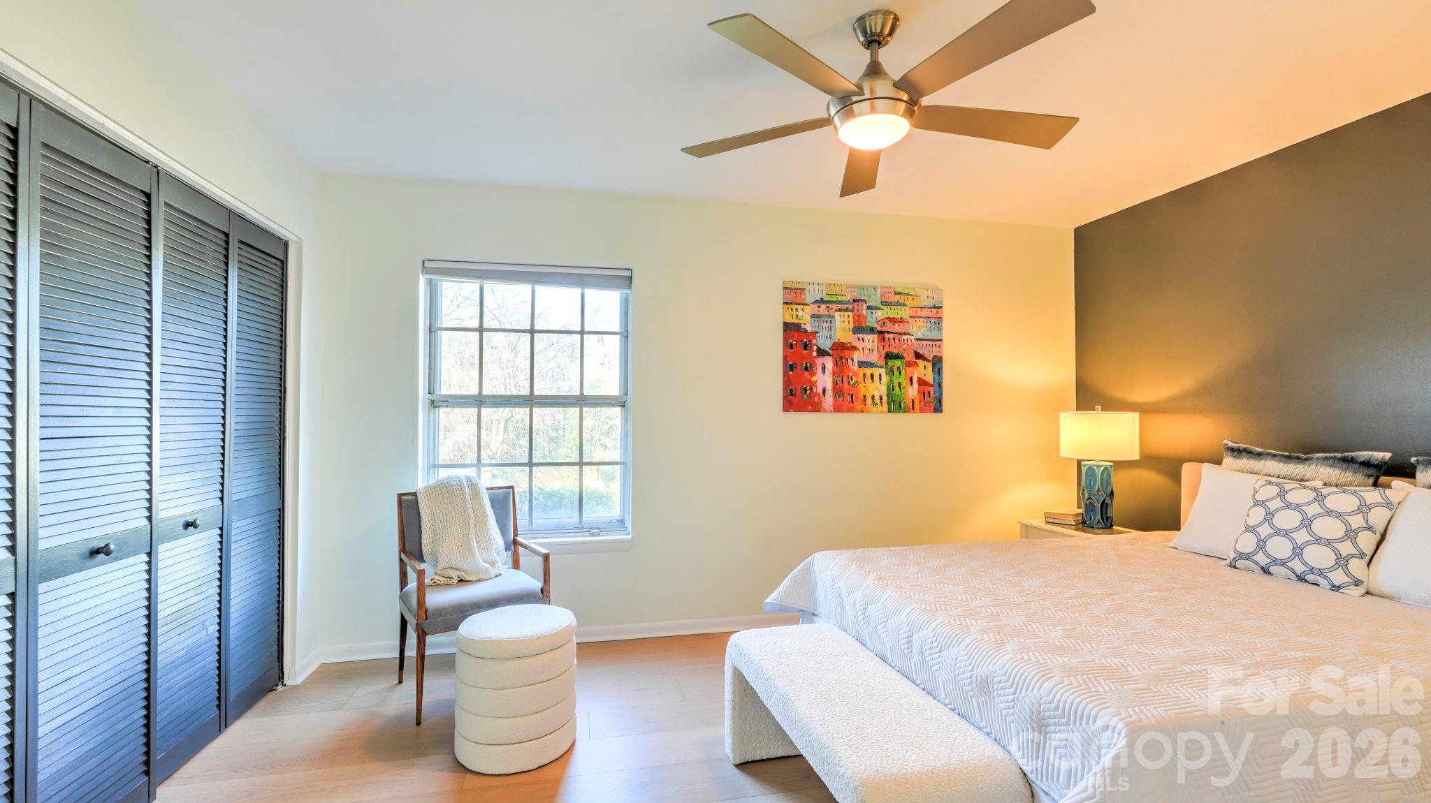 2626 Park Road, Unit B Charlotte, NC 28209 - Photo 12 of 31 a bedroom with a bed and a chair