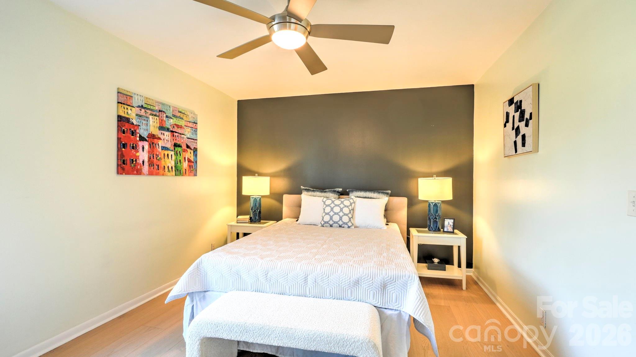 2626 Park Road, Unit B Charlotte, NC 28209 - Photo 13 of 31 a bedroom with a bed and a painting on the wall