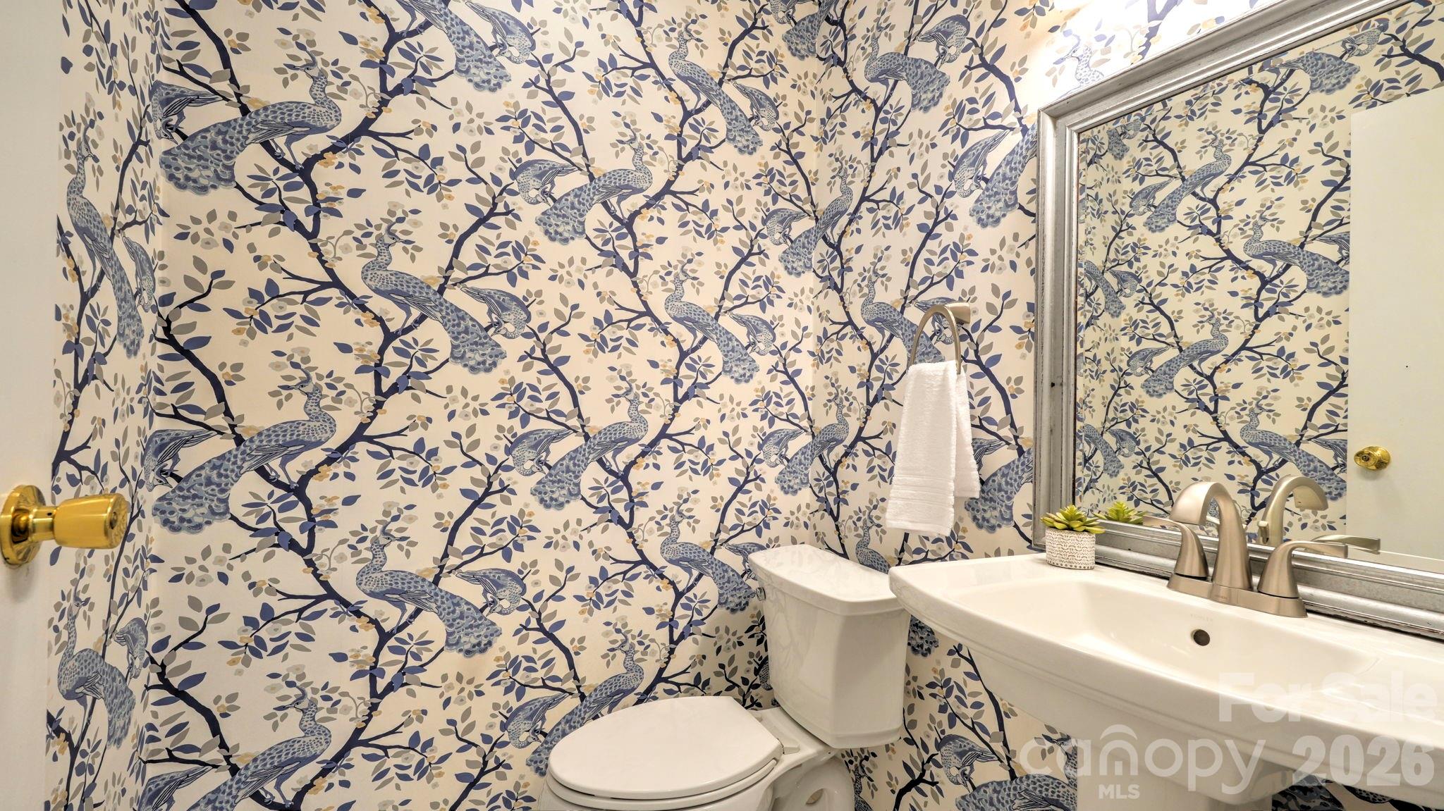 2626 Park Road, Unit B Charlotte, NC 28209 - Photo 15 of 31 a bathroom with a toilet sink and mirror