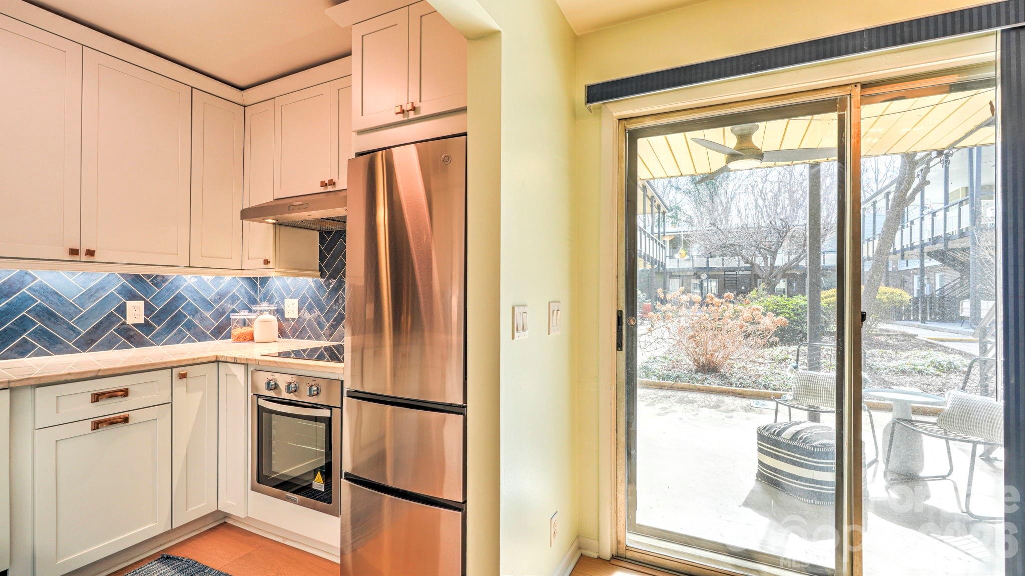 2626 Park Road, Unit B Charlotte, NC 28209 - Photo 5 of 31 a kitchen with stainless steel appliances granite countertop a refrigerator and a cabinets