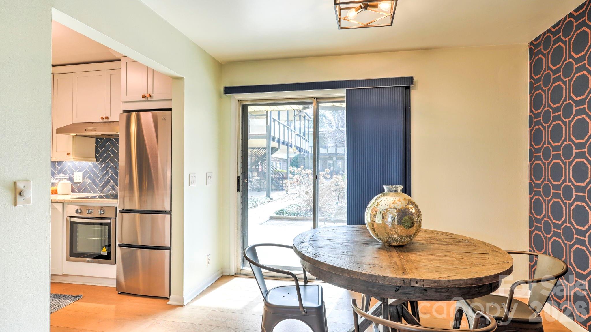 2626 Park Road, Unit B Charlotte, NC 28209 - Photo 6 of 31 a kitchen with stainless steel appliances granite countertop a refrigerator and a wooden cabinets