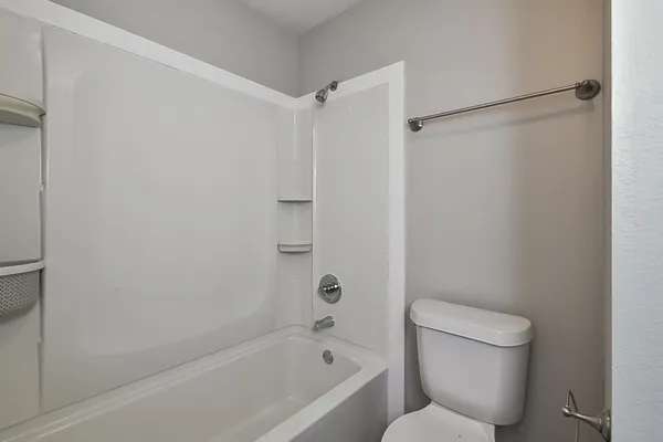 a bathroom with a toilet and a bathtub