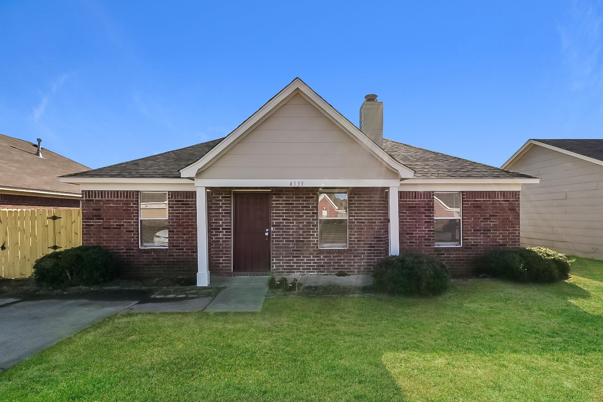 4539 Longtree Avenue Memphis, TN 38128 - Photo 2 of 16 a view of a brick house with a yard potted plants and a table
