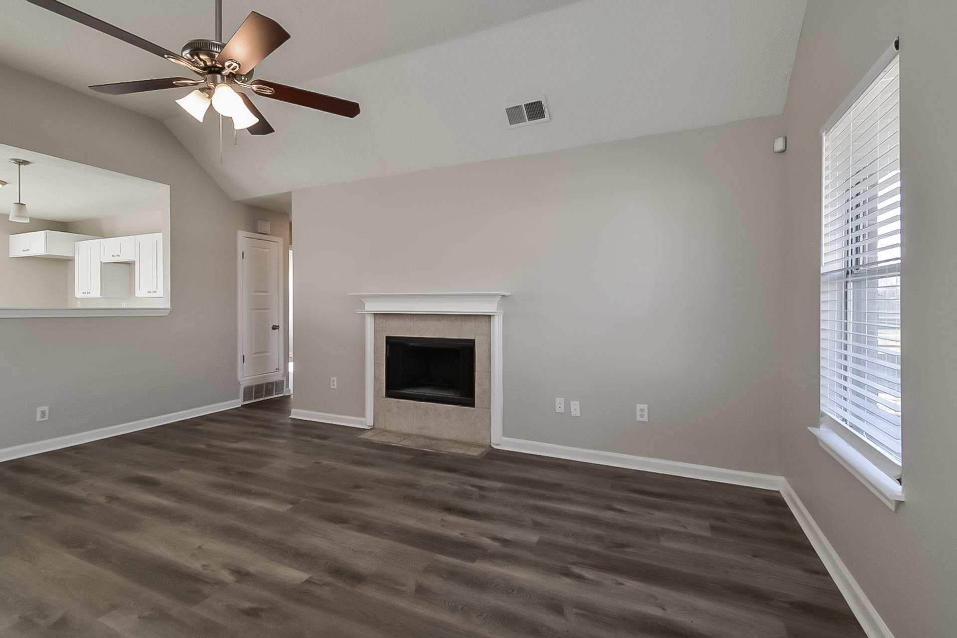 4539 Longtree Avenue Memphis, TN 38128 - Photo 4 of 16 a view of an empty room with window and wooden floor