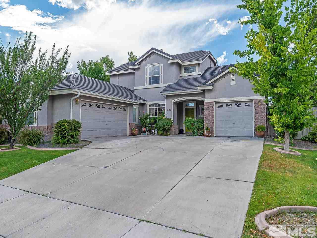 10675 Silver Cliff Way Reno, NV 89521 - Photo 1 of 16 a front view of a house with a yard and garage