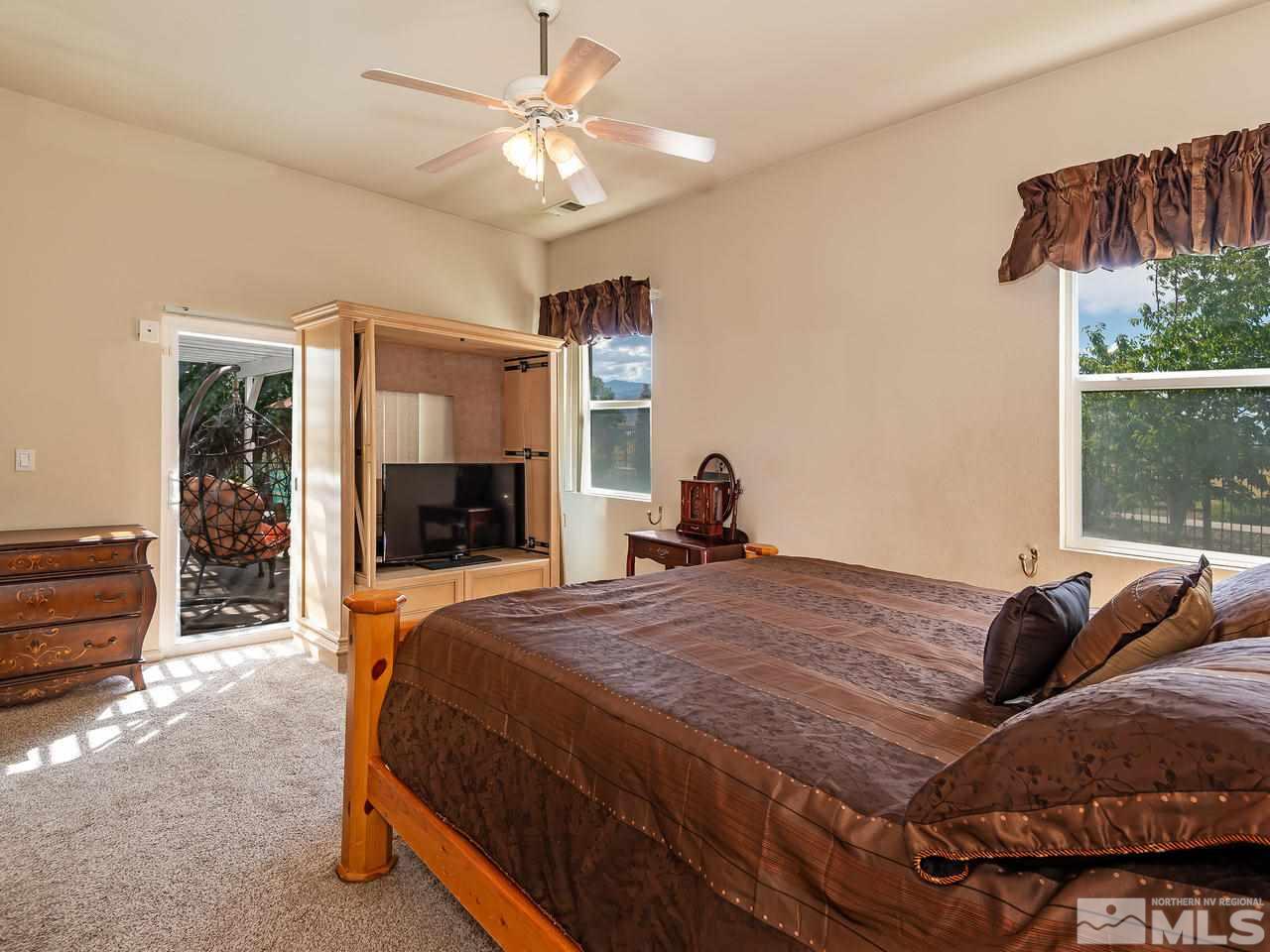 10675 Silver Cliff Way Reno, NV 89521 - Photo 11 of 16 a bedroom with a bed dresser and a large window