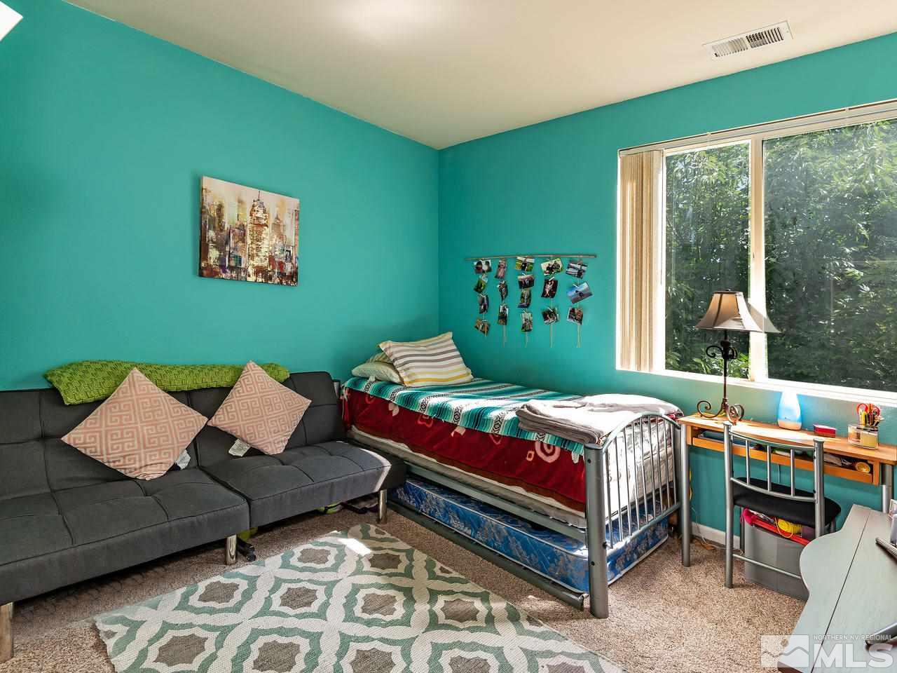 10675 Silver Cliff Way Reno, NV 89521 - Photo 14 of 16 a bedroom with a bed and window