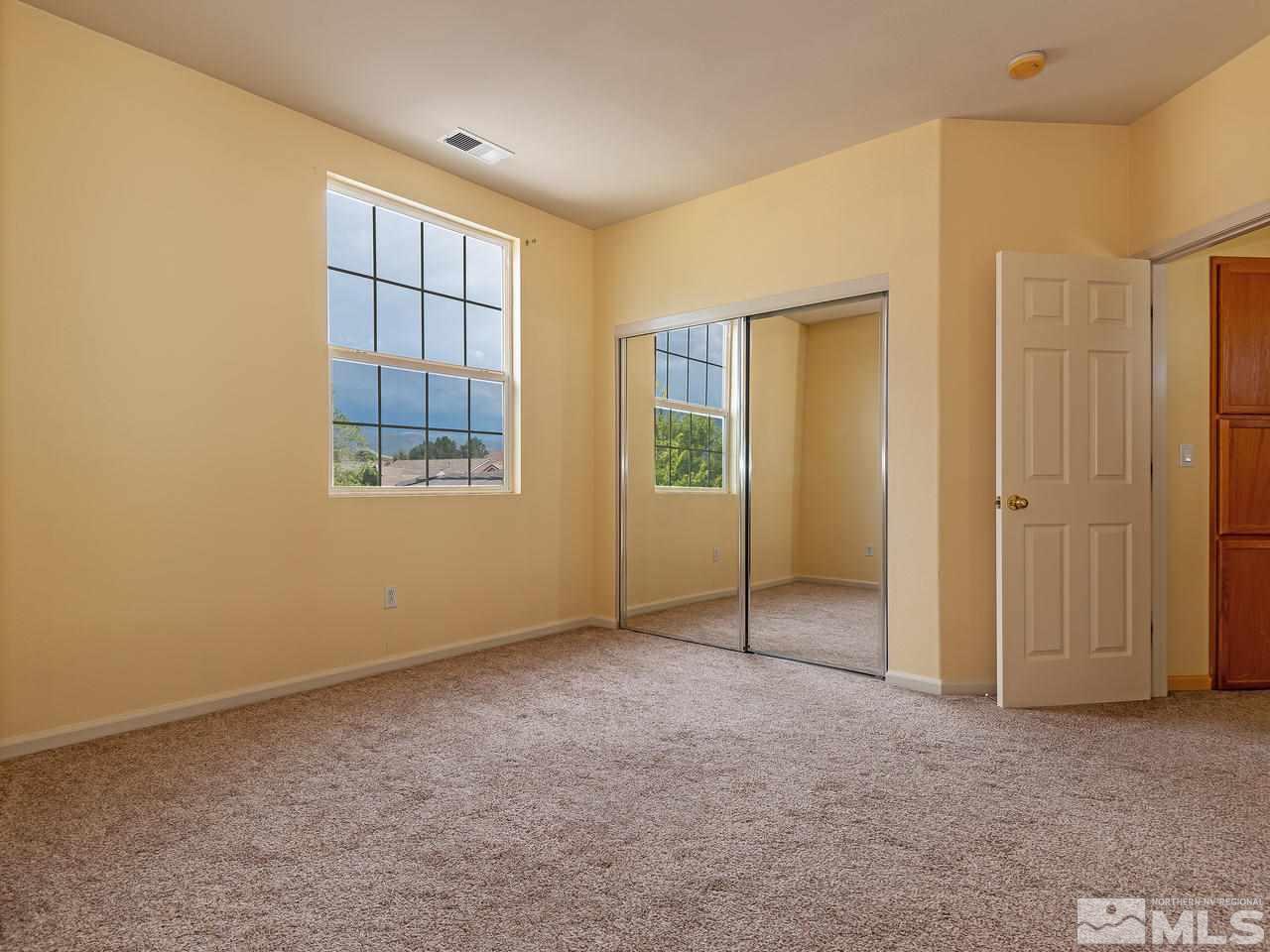 10675 Silver Cliff Way Reno, NV 89521 - Photo 15 of 16 an empty room with windows and closet