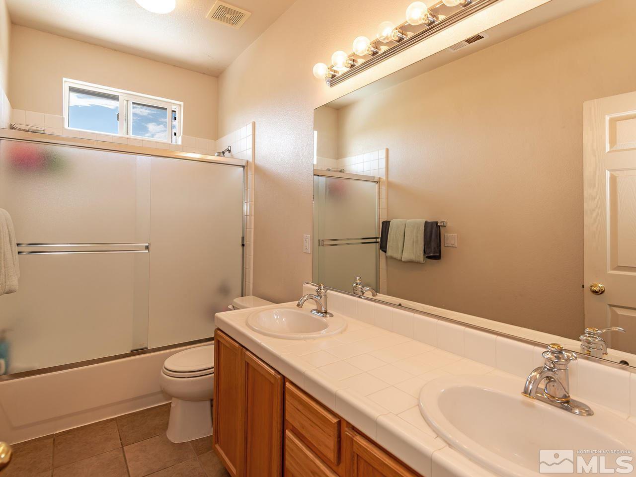 10675 Silver Cliff Way Reno, NV 89521 - Photo 16 of 16 a bathroom with a sink and mirror