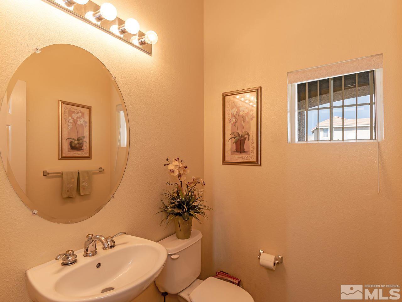 10675 Silver Cliff Way Reno, NV 89521 - Photo 10 of 16 a bathroom with a toilet sink and mirror