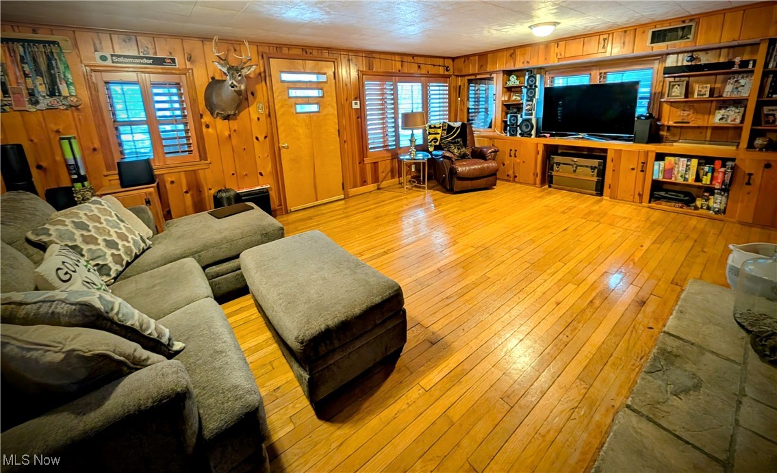 544 Maple Lake Road Bridgeport, WV 26330 - Photo 10 of 20 Living room featuring light wood-type flooring and wood walls