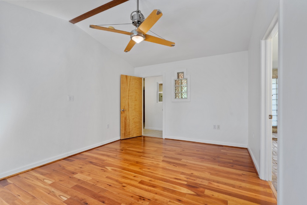 1212 Bentwood Road Austin, TX 78722 - Photo 23 of 32 an empty room with wooden floor and windows