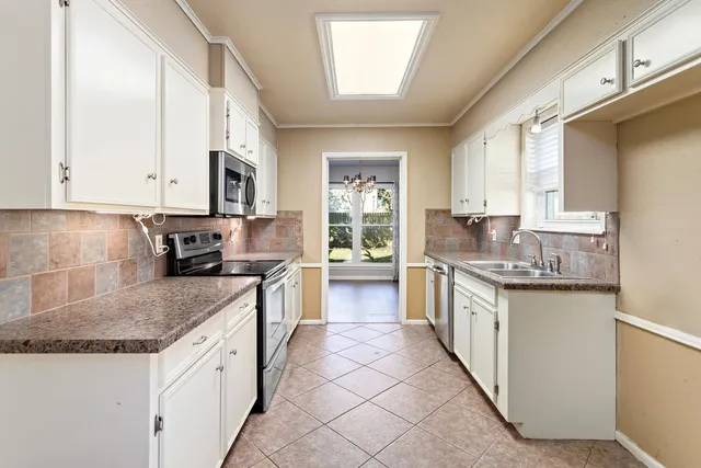 a kitchen with stainless steel appliances granite countertop a stove a sink and a granite counter tops