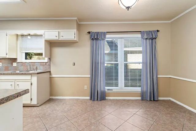 a view of kitchen with granite countertop cabinets