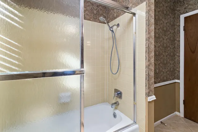 a bathroom with a shower and a shower