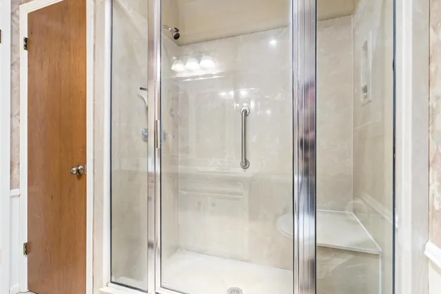 a bathroom with a glass shower door