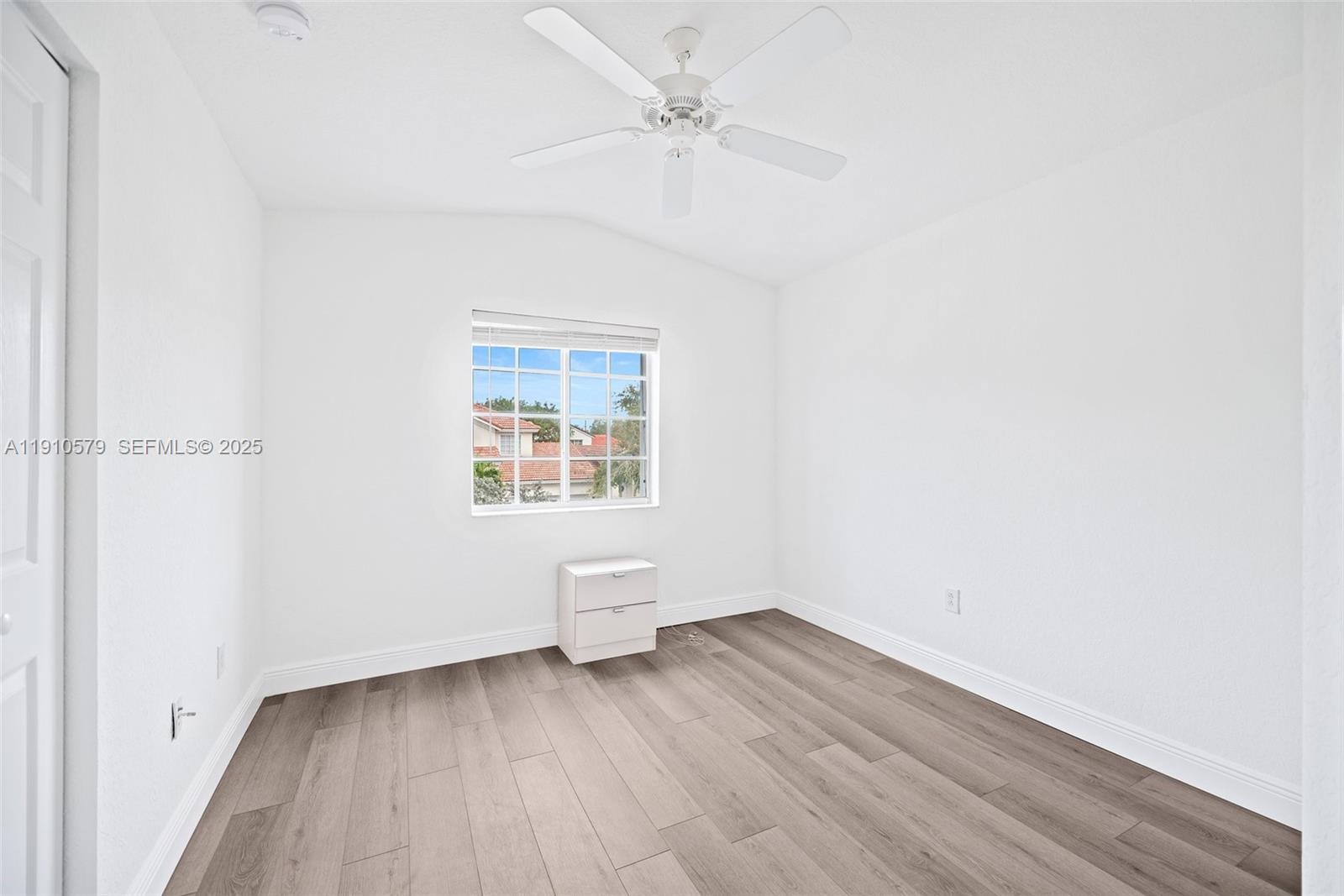 18746 Southwest 27th Court Miramar, FL 33029 - Photo 14 of 35 an empty room with wooden floor and windows