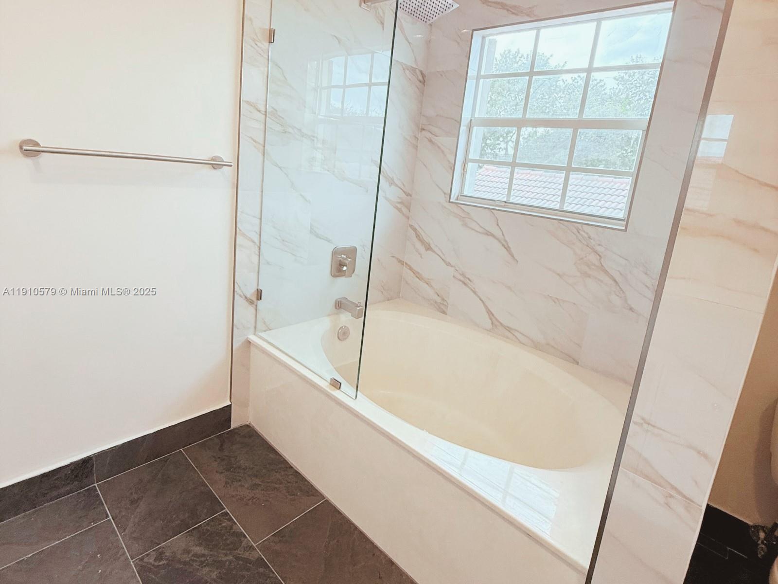 18746 Southwest 27th Court Miramar, FL 33029 - Photo 18 of 35 a bathroom with a bathtub and a shower