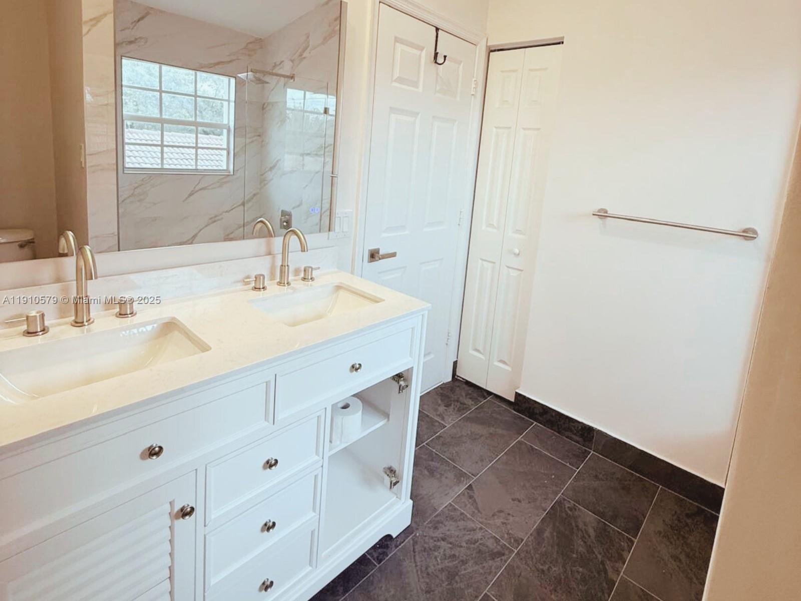 18746 Southwest 27th Court Miramar, FL 33029 - Photo 21 of 35 a bathroom with a sink and a mirror
