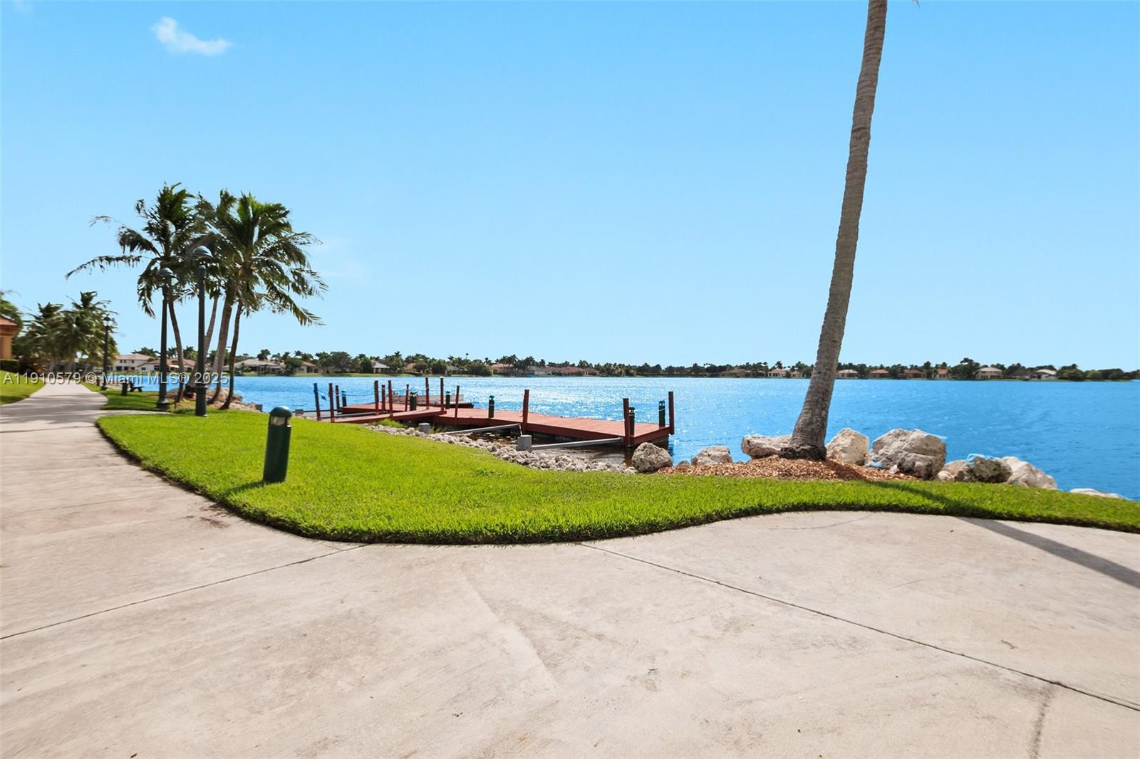 18746 Southwest 27th Court Miramar, FL 33029 - Photo 27 of 35 a view of a swimming pool with a yard and palm trees