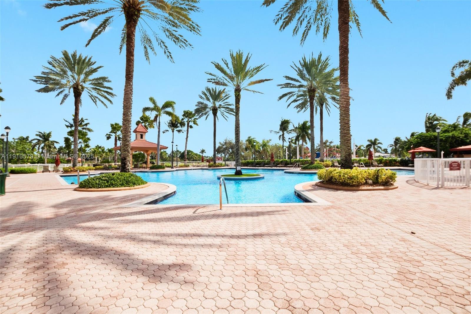 18746 Southwest 27th Court Miramar, FL 33029 - Photo 28 of 35 a view of a swimming pool with a lawn chairs and palm trees