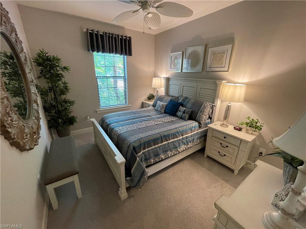 8328 Lucello Terrace North Naples, FL 34114 - Photo 12 of 22 a bedroom with a bed and a chandelier