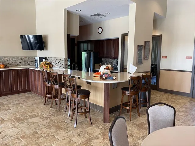 a dining room with furniture and a large window