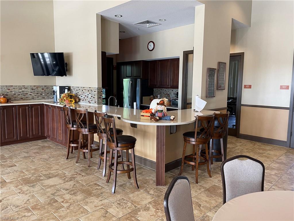 8328 Lucello Terrace North Naples, FL 34114 - Photo 17 of 22 a dining room with furniture and a large window
