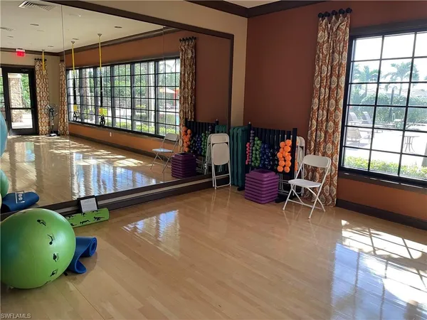 a room with lots of furniture and a large window