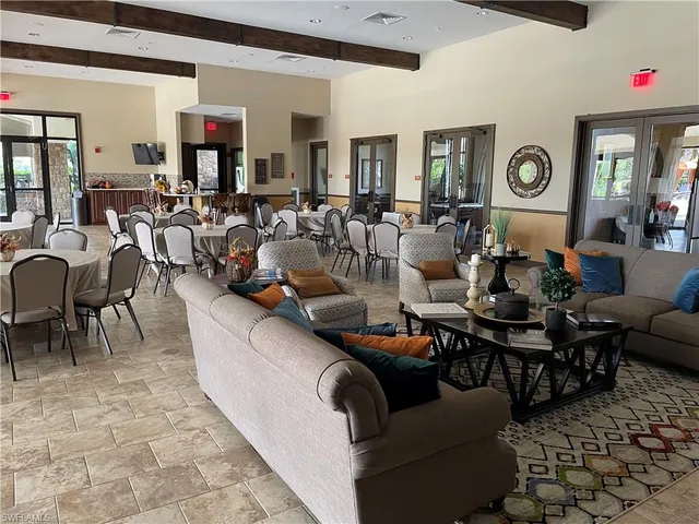 a living room with lots of furniture and view of kitchen