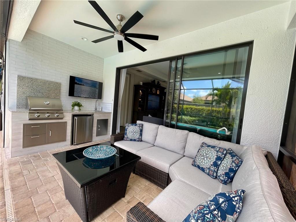 8328 Lucello Terrace North Naples, FL 34114 - Photo 21 of 22 a living room with furniture and a flat screen tv