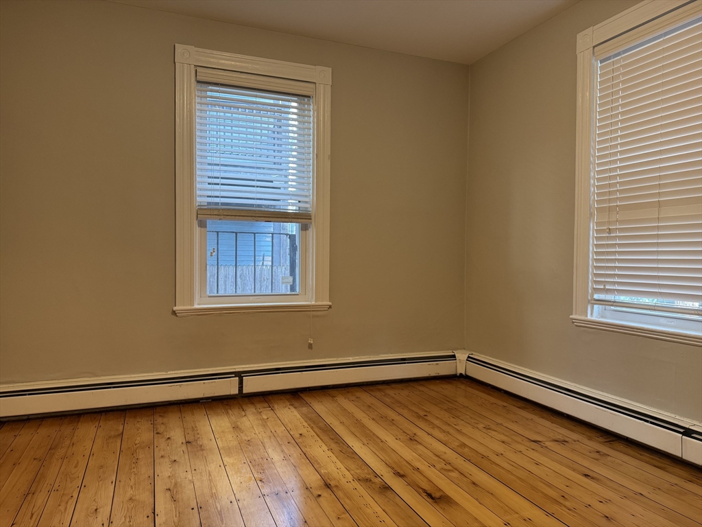 9 Kenney Street, Unit 1 Boston, MA 02130 - Photo 4 of 12 a view of a room with wooden floor and a window