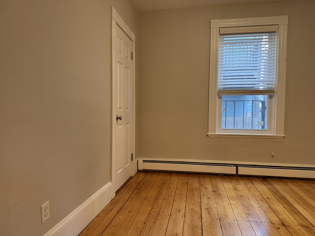 9 Kenney Street, Unit 1 Boston, MA 02130 - Photo 5 of 12 a view of a room with wooden floor and a window