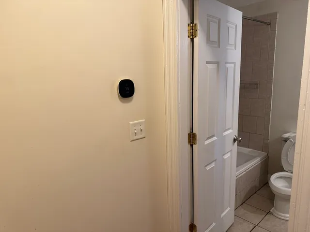 a bathroom with a granite countertop toilet and a shower