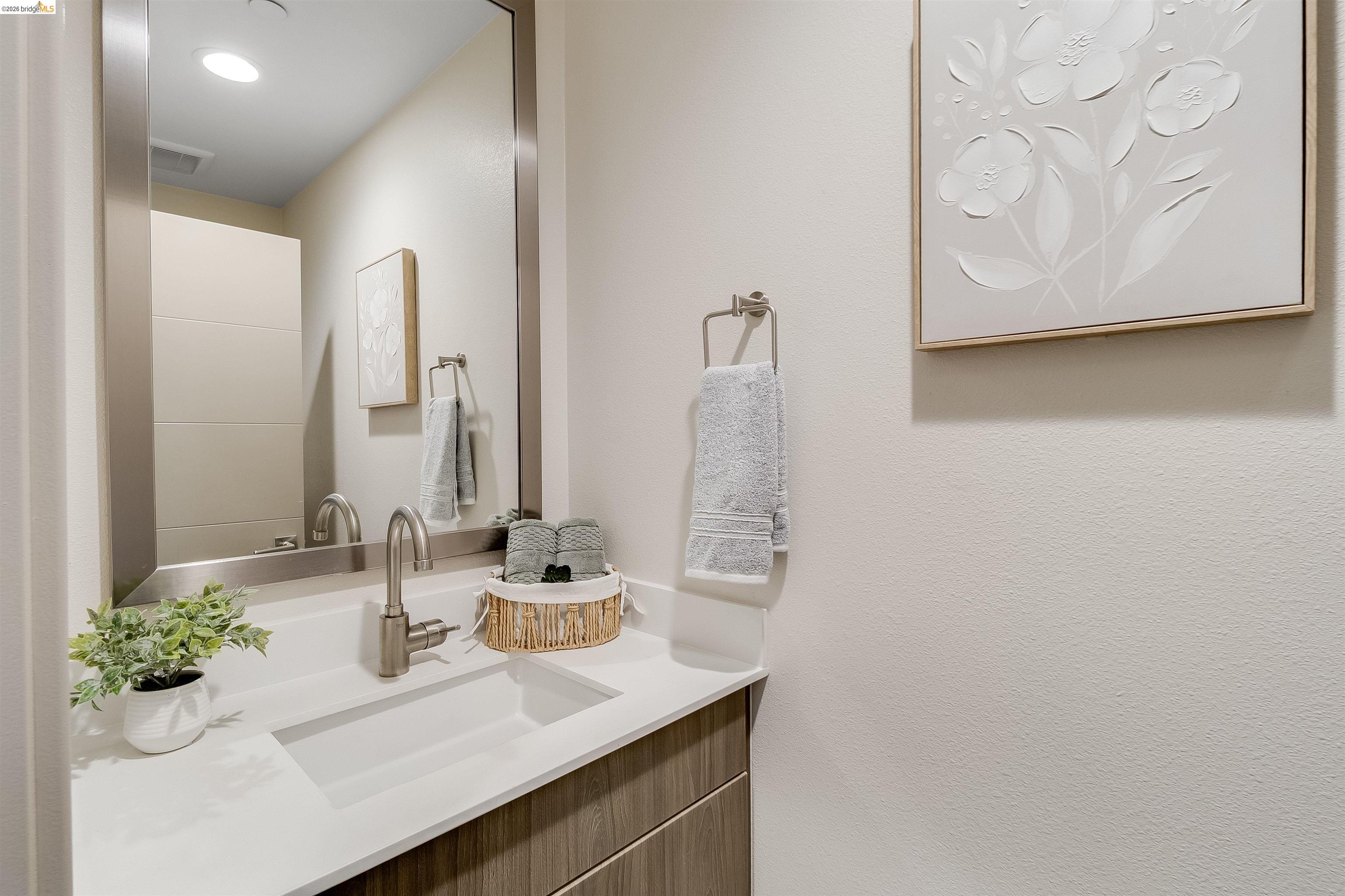 1357 Pullman Way Oakland, CA 94607 - Photo 16 of 37 Modern vanity featuring a rectangular undermount sink, a sleek brushed nickel faucet, and a stone-finish countertop