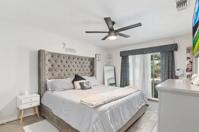 a bedroom with a large bed and a chandelier