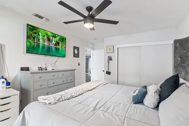 a bedroom with a bed and a flat screen tv