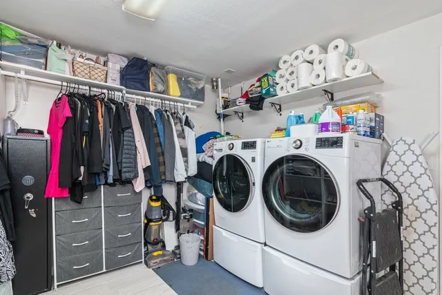 a view of walk in closet with clothes and shoes