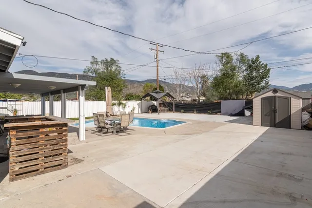 a view of a patio with a table and chairs
