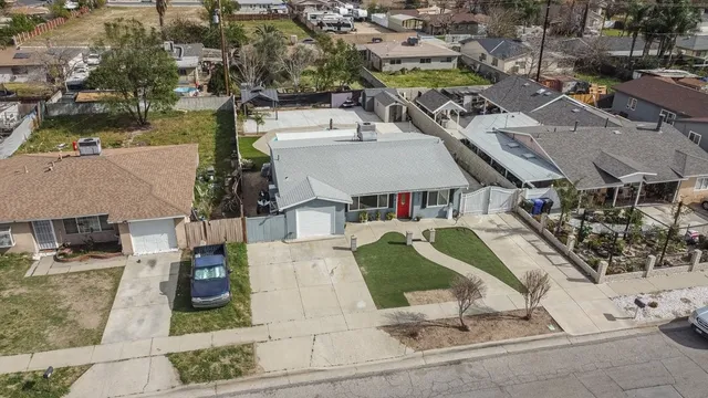 an aerial view of a house with garden space and parking