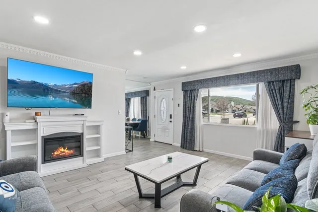 a living room with furniture a rug and a fireplace