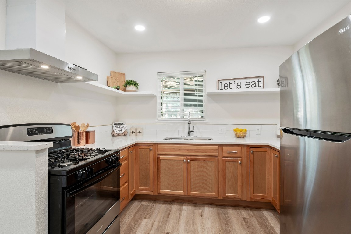 4913 Hawk Cove, Unit B Austin, TX 78745 - Photo 1 of 21 a kitchen with stainless steel appliances a sink stove and refrigerator