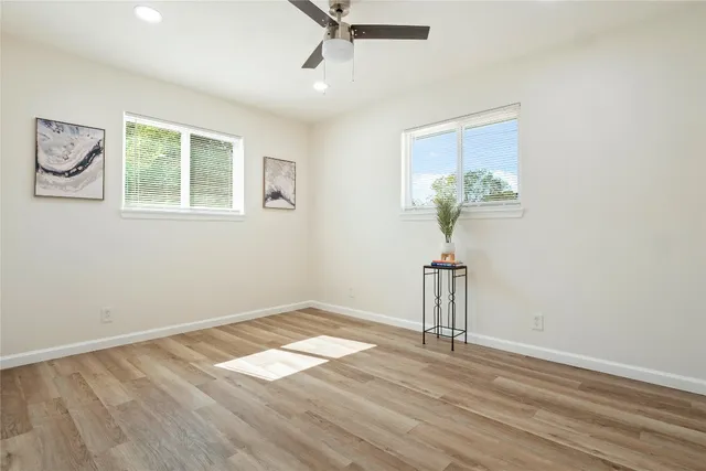 a view of a room with a window and wooden floor