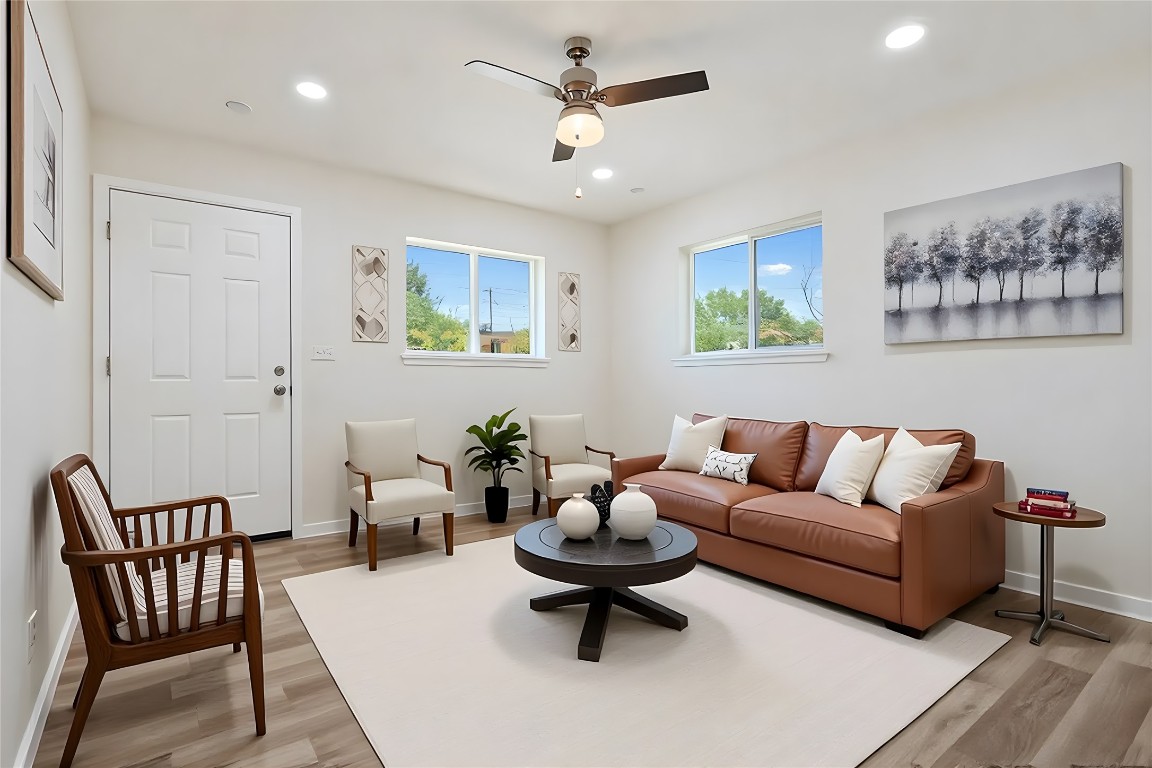 4913 Hawk Cove, Unit B Austin, TX 78745 - Photo 5 of 21 a living room with furniture a rug and a chandelier