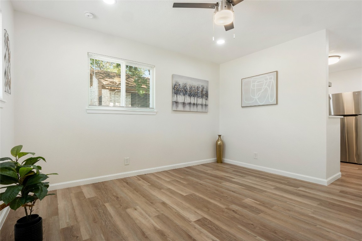 4913 Hawk Cove, Unit B Austin, TX 78745 - Photo 7 of 21 wooden floor in an empty room with a window
