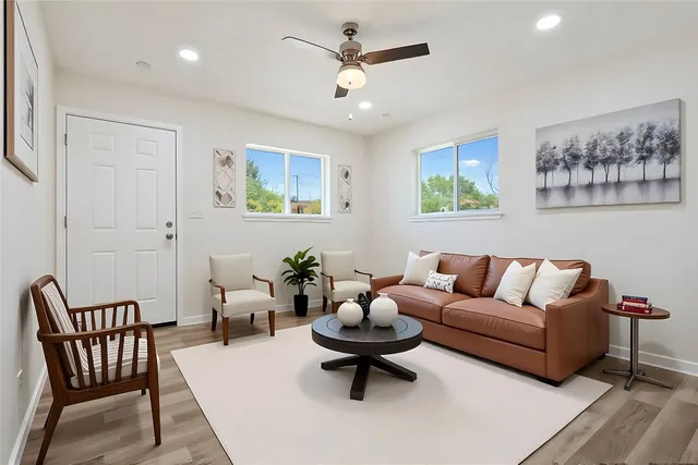 a living room with furniture a rug and a chandelier
