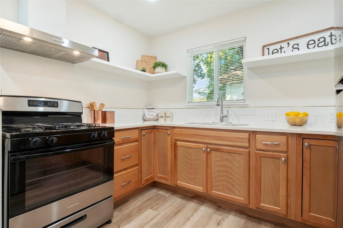 4913 Hawk Cove, Unit B Austin, TX 78745 - Photo 10 of 21 a kitchen with a sink stove and cabinets