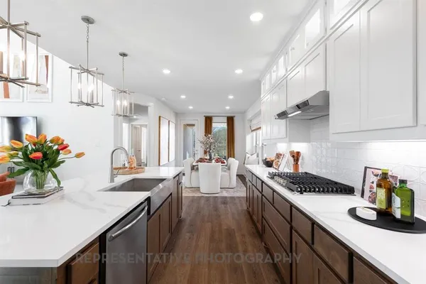 a kitchen with counter top space and wooden floor