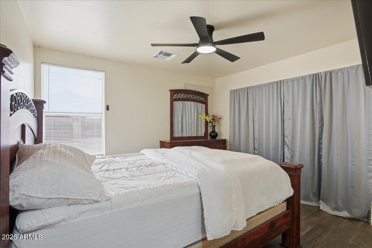 1825 West Renaissance Avenue Apache Junction, AZ 85120 - Photo 12 of 23 a bedroom with a large bed and a chandelier
